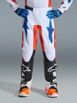 Spodnie cross dziecięce Alpinestars MX Fluid Grid pomarańczowo-biało-niebieskie